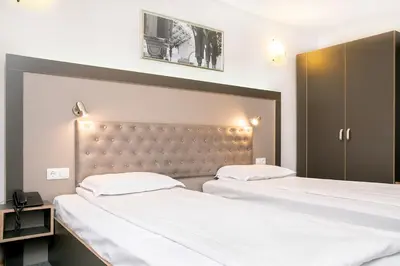 a bedroom with two beds and a headboard at Hotel Niky in Sofia