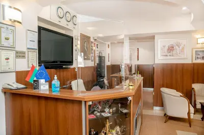 a room with a reception desk with a tv at Hotel Niky in Sofia