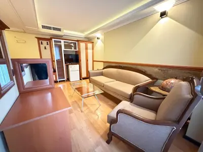 a living room with a couch and a tv at California Hotel in Sofia