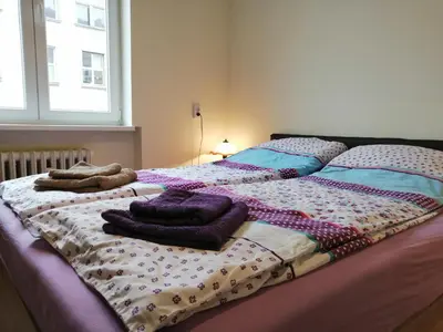 two beds with pillows on them in a bedroom at Central Academic Apartment Sofia in Sofia