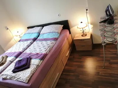 a bed in a room with two lamps and a bed sidx sidx sidx at Central Academic Apartment Sofia in Sofia