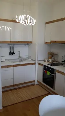 a kitchen with white cabinets and a black oven at Michelle Apartment in Sofia