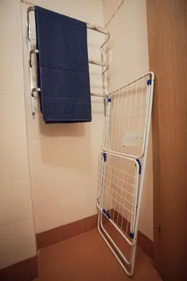 a towel rack in a bathroom with a blue towel at Michelle Apartment in Sofia