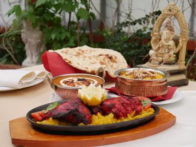 a plate of food on a table with food at Michelle Apartment in Sofia