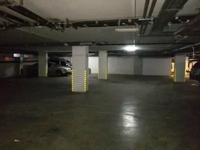 an empty parking lot with yellow poles in a parking garage at Alliance Hotel in Plovdiv