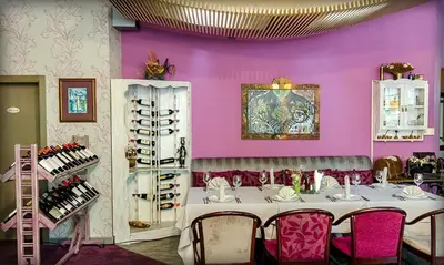 a dining room with a table and purple walls at Alliance Hotel in Plovdiv