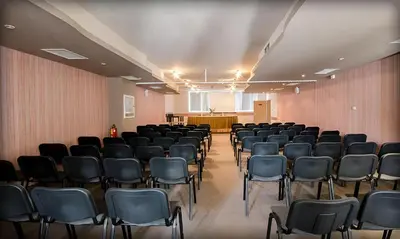 an empty room with chairs and a podium in the background at Alliance Hotel in Plovdiv