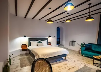a bedroom with a bed and a couch at My Guest Rooms in Plovdiv