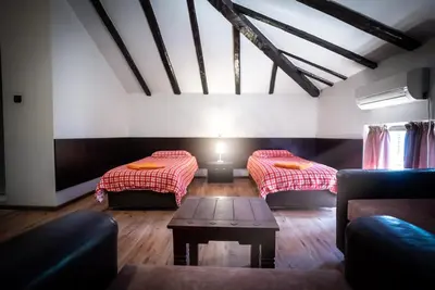 a living room with two beds and a table at My Guest Rooms in Plovdiv