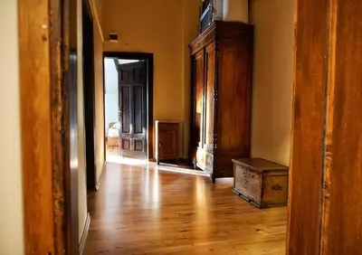 an empty room with a wooden floor and an open door at My Guest Rooms in Plovdiv