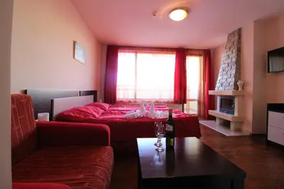 a living room with a bed and a couch at Mountview Lodge Apartments in Bansko