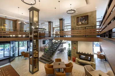 an open lobby with a staircase and a living room at Lion Hotel Borovets in Borovets
