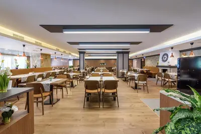 a dining room with tables and chairs at Lion Hotel Borovets in Borovets