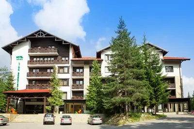 a building with cars parked in front of it at Lion Hotel Borovets in Borovets