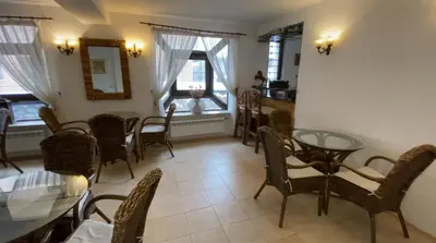 a dining room with a glass table and chairs at Aneli Hotel in Bansko