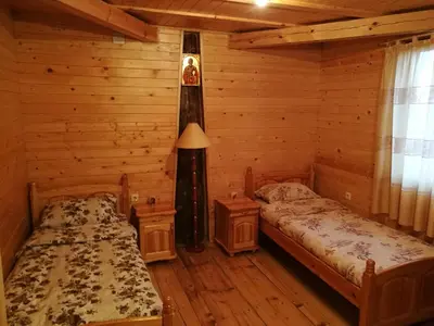 a bedroom with two beds in a log cabin at Tree House in Sofia