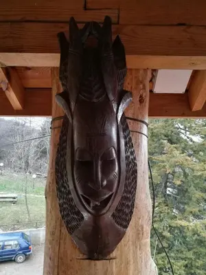 a wooden mask on the side of a porch at Tree House in Sofia