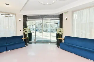 a lobby with blue couches and a glass door at Art Plaza Hotel in Sofia