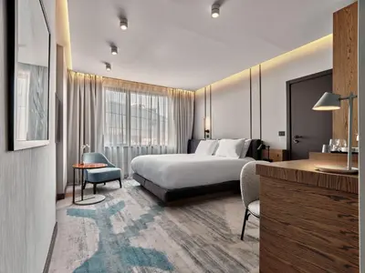 a hotel room with a bed and a desk at Crowne Plaza Sofia by IHG in Sofia