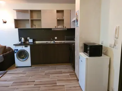a kitchen with a washing machine and a washer at Apart Hotel Dream in Bansko