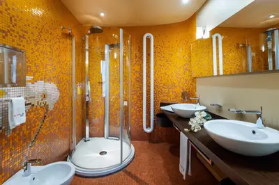 a bathroom with two sinks and a shower at Les Fleurs Boutique Hotel in Sofia