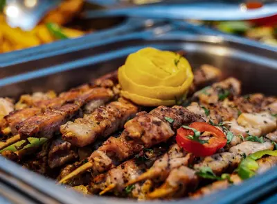 a pan of food with meat and mustard on it at MPM Hotel Guinness in Bansko