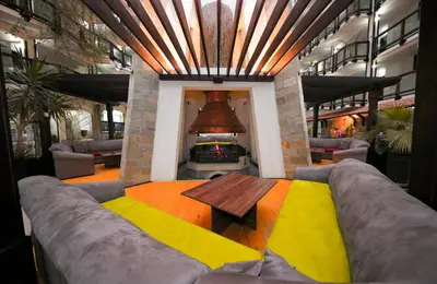 a living room with a couch and a table at MPM Hotel Guinness in Bansko
