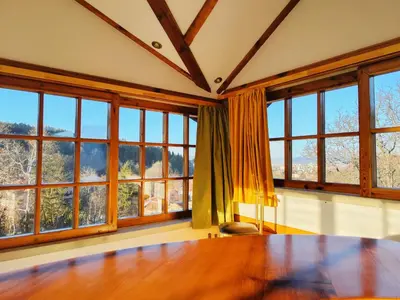 a room with large windows and a wooden table at Park Hotel Amfora -Free Parking in Sofia
