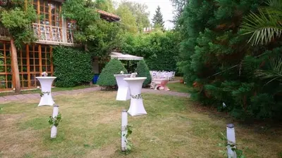 a garden with white candles in the grass at Park Hotel Amfora -Free Parking in Sofia