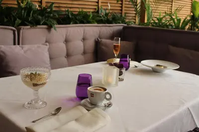 a table with a white table cloth and a cup of coffee at Casa Boyana Boutique Hotel in Sofia