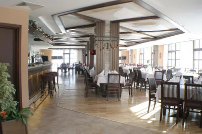 a dining room with tables and chairs in a restaurant at Lion Bansko Hotel in Bansko