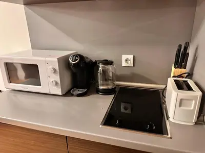 a microwave sitting on top of a kitchen counter at Mountain Paradise 2, One bedroom apartment in Bansko