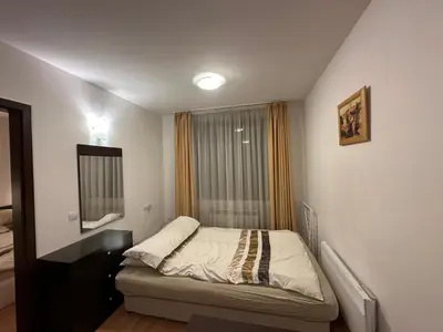 a small bedroom with a bed and a window at Mountain Paradise 2, One bedroom apartment in Bansko