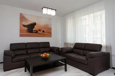 a living room with two couches and a coffee table at Grand Vitosha Apartments in Sofia
