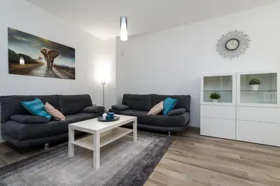 a living room with a couch and a table at Grand Vitosha Apartments in Sofia
