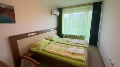 a small bedroom with a bed and a window at Hotel Gorna Banya in Sofia