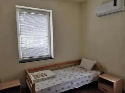 a small bedroom with a bed and a window at Guesthouse Tzar Asen in Sofia