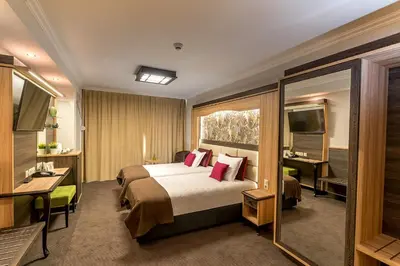 a hotel room with a bed and a television at Hotel ZOO Sofia in Sofia