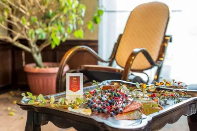 a table with a plate of food on it at Chateau Montagne Hotel Troyan in Troyan