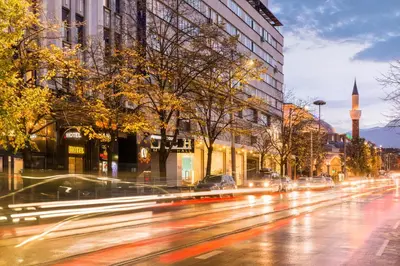 a city street with buildings and a clock tower at Hotel Central Club Sofia in Sofia