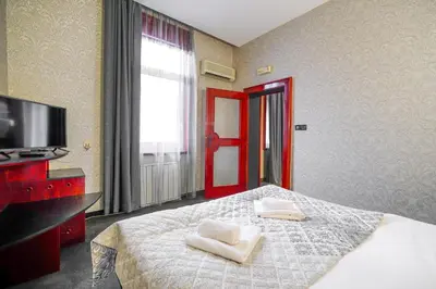 a bedroom with a bed with two white towels on it at Hotel Central Club Sofia in Sofia