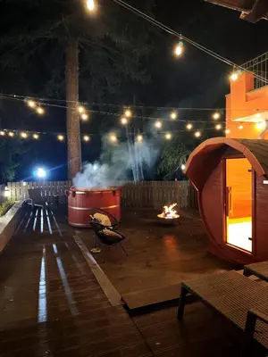 a patio at night with a fire pit and lights at Villa Sokol in Borovets