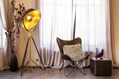 a lamp and a chair in front of a window at Villa Sokol in Borovets