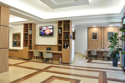 a lobby with a waiting room with a tv on the wall at Legends Hotel in Sofia