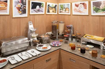 a kitchen with a counter with food on it at Legends Hotel in Sofia