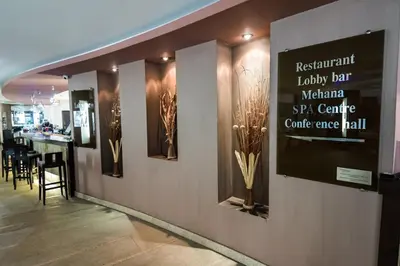 a restaurant loyalty bar with a sign on the wall at Gardenia Park Hotel in Bansko