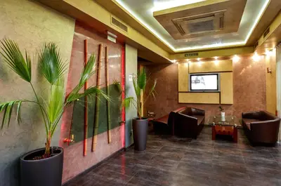 a lobby with chairs and plants on the wall at Hotel Gabi in Plovdiv