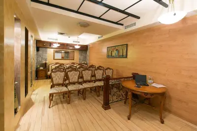 a conference room with chairs and a table with a laptop at Hotel Gabi in Plovdiv