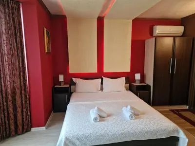 a bedroom with a bed with two towels on it at Hotel Gabi in Plovdiv