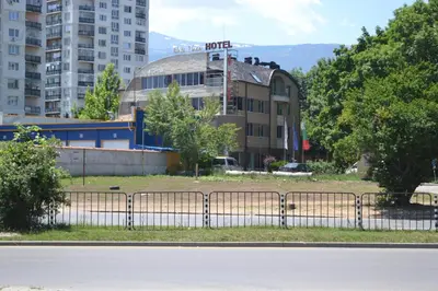 a fence in front of a building in a city at Elate Plaza Hotel in Sofia
